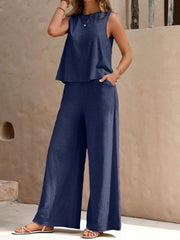 Relaxed linen tank and palazzo pant set in dusty blue, with wide leg pants and a sleeveless top.