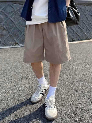 Relaxed fit khaki chino shorts with elastic waistband, breathable fabric, and casual styling.
