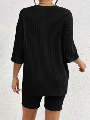 Black ribbed lounge set with relaxed fit top and biker shorts.