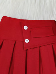 Wine red pleated skirt with decorative buttons and pocket detail