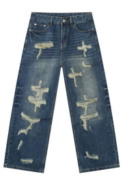 Oversized ripped denim jeans in medium wash with a wide-leg silhouette and distressed details.