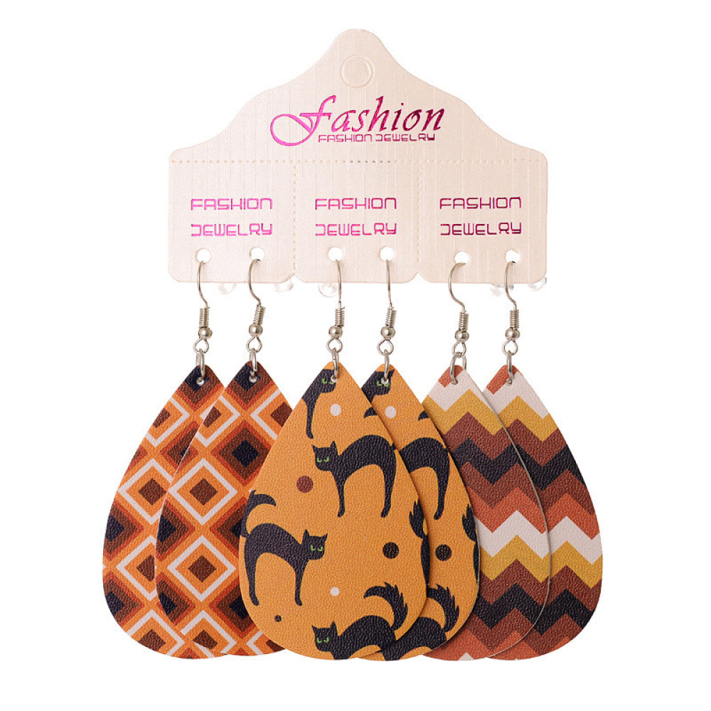 Spooky print teardrop earrings with black cats and geometric patterns.