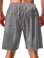 Men's grey quilted texture drawstring chino shorts with diamond pattern.