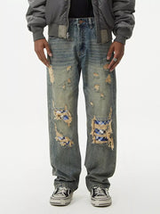 Distressed denim wide leg jeans with plaid patches and frayed details.