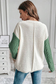 Colorblock cable knit sweater in cream and gum leaf green with textured sleeves.