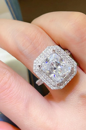 Radiant cut moissanite halo ring in silver with a double halo of small stones.
