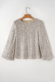 Sequin blouson top in ivory with long bell sleeves and a round neckline.