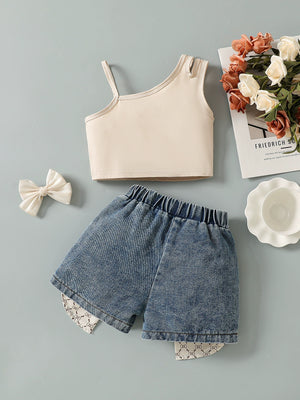 Baby girls' beige asymmetrical tank top and denim shorts set with bow accents.