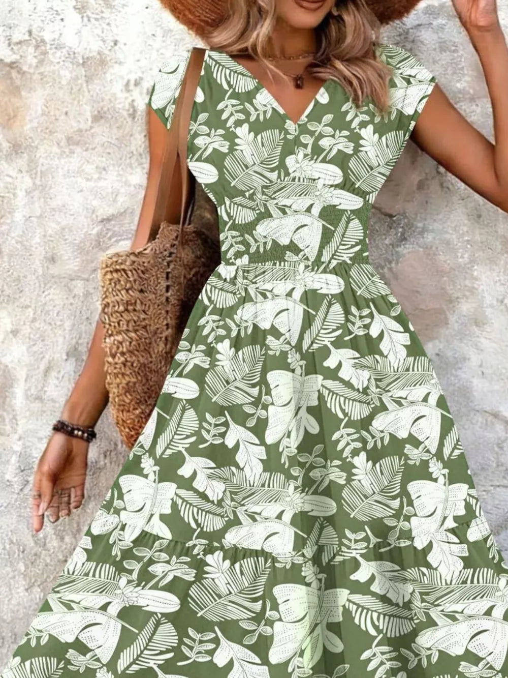 Green tiered maxi dress with white leaf print, smocked bodice, and V-neck.