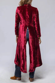 Burgundy velvet duster coat with dramatic split back, long sleeves, and flowing hem.