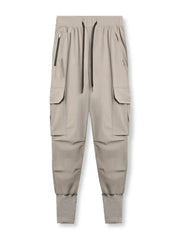 Technical cargo joggers in mocha with ribbed cuffs and zip pockets.