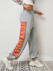 Heather Gray sweatpants with orange and red graphic text down the leg.