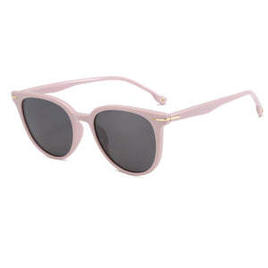Blush pink cat-eye sunglasses with dark lenses and gold accents on the temples.