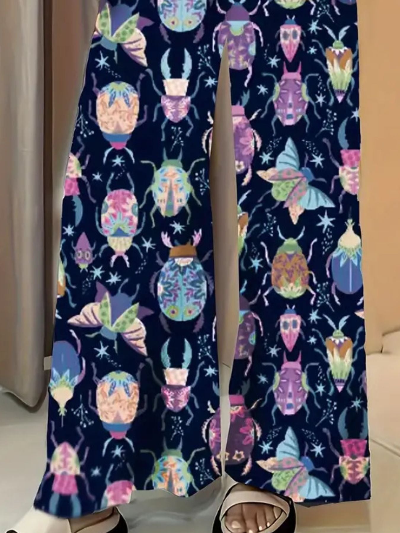 Dark blue wide-leg maternity trousers with a colorful beetle and butterfly print.