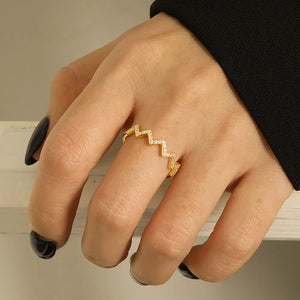 Gold zigzag pavé band ring with clear stones