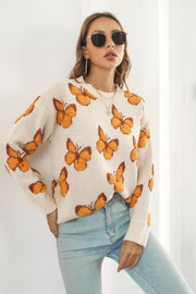 Beige acrylic knit crewneck pullover sweater with allover orange butterfly motif.