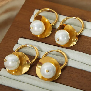 Golden petal pearl drop hoop earrings with a polished finish.