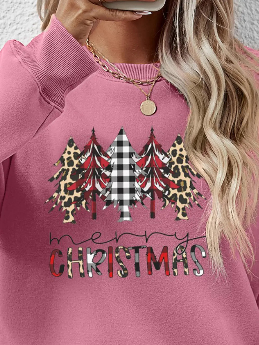 Blush pink crewneck sweatshirt with Christmas trees in buffalo plaid, leopard print, and red plaid, and "Merry Christmas"