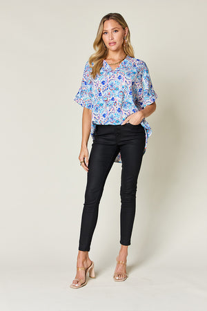 Floral ikat relaxed v-neck blouse with short flutter sleeves in pink and sky blue.