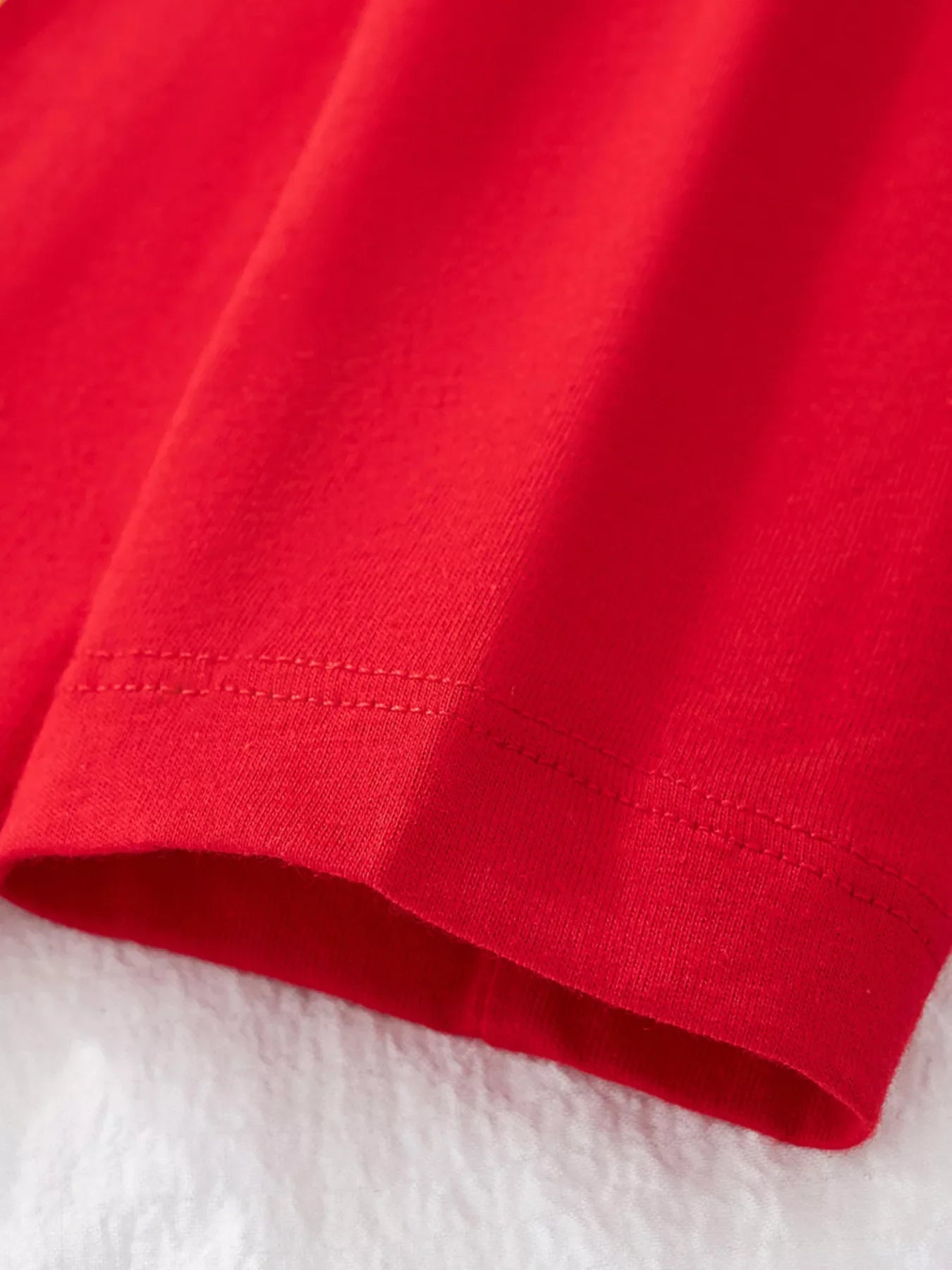 Red cotton t-shirt hem detail with double stitching
