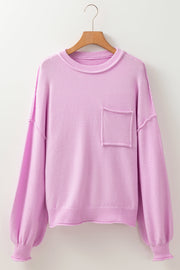 Pink knit sweater with contrast stitching, crewneck, puffed sleeves, and chest pocket.