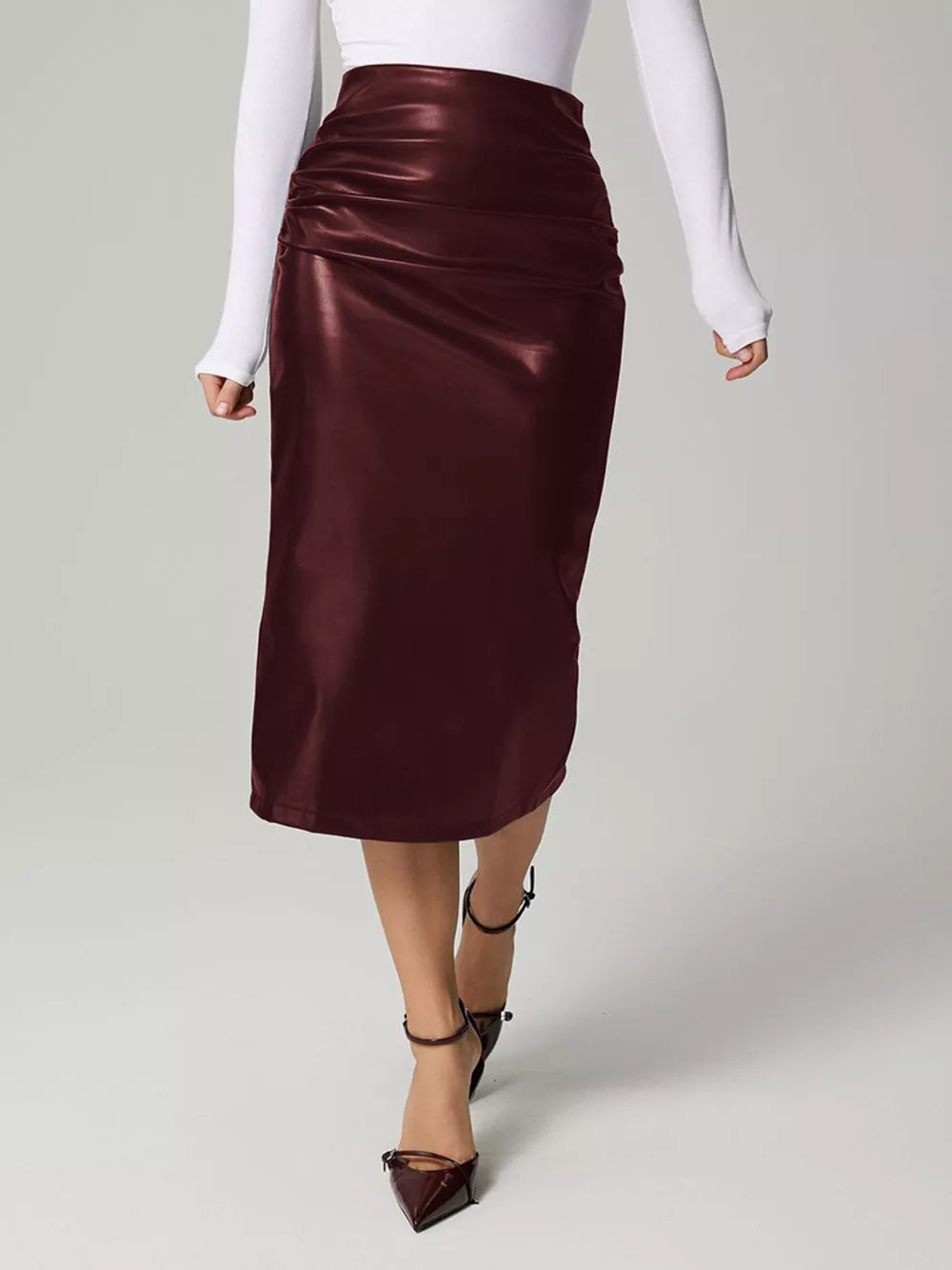 Burgundy high-waisted ruched faux leather midi skirt with a body-con fit.