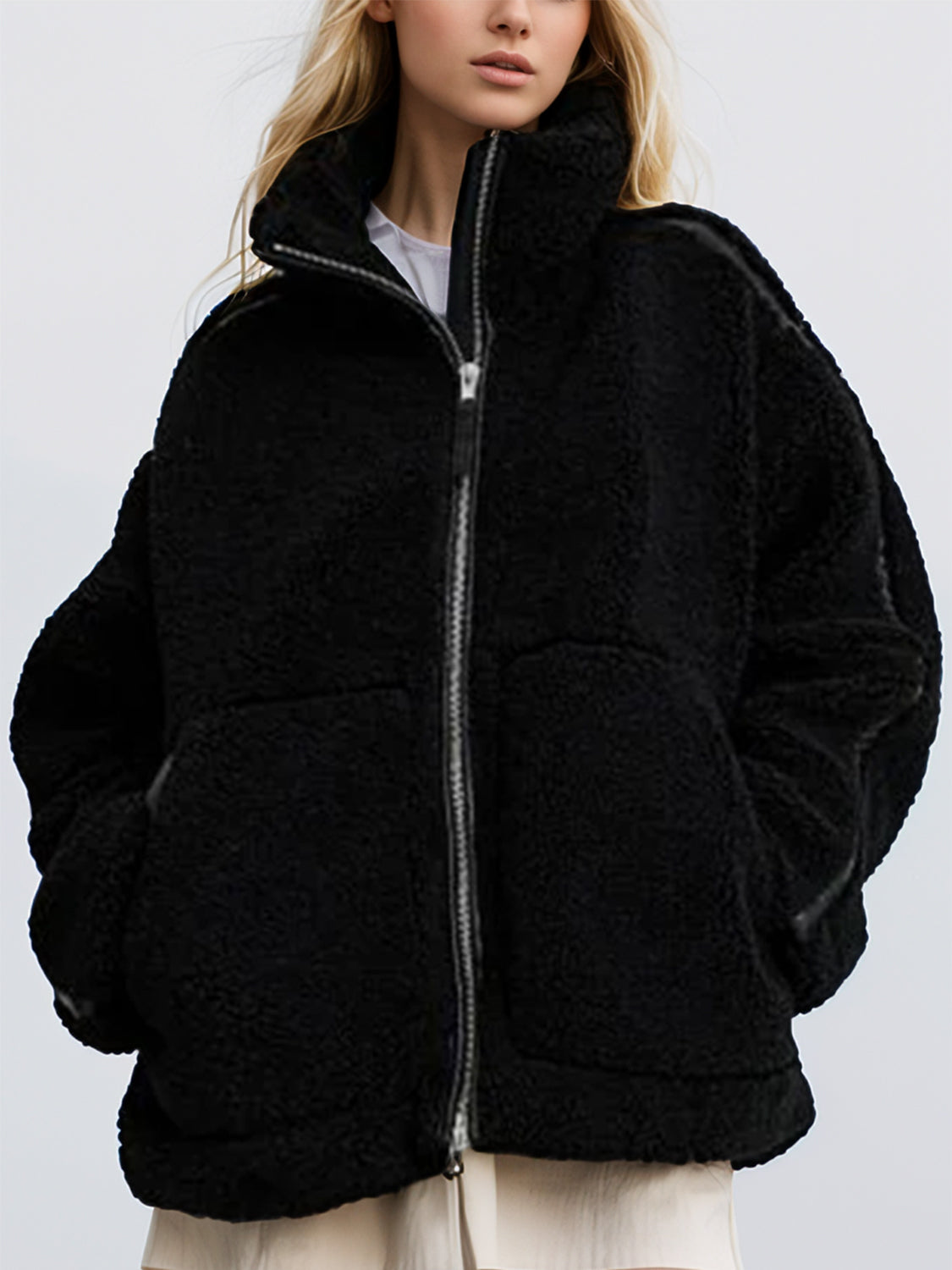 Black teddy fleece zip-up jacket with contrast piping and a high collar.