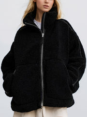 Black teddy fleece zip-up jacket with contrast piping and a high collar.