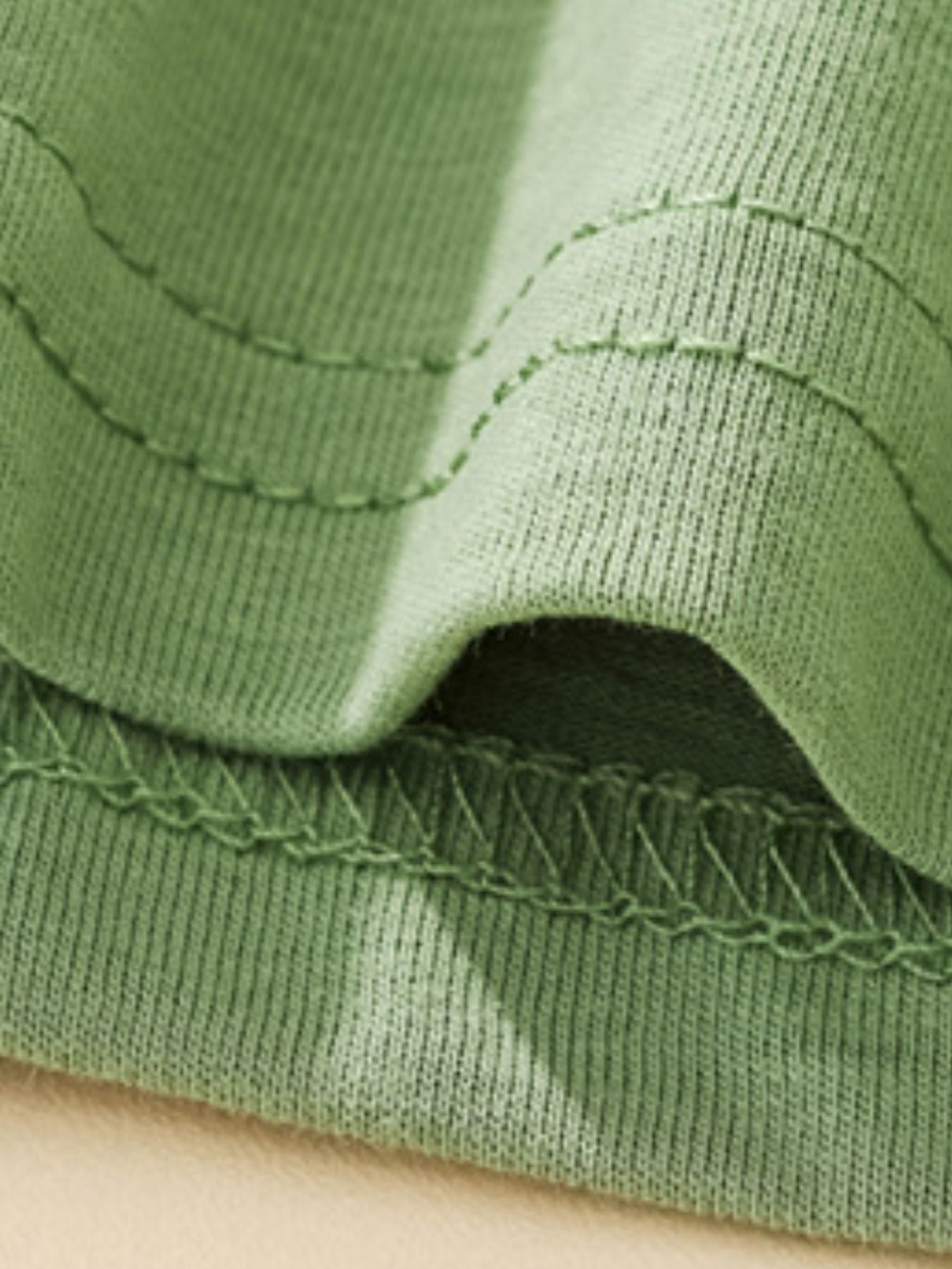 Green cotton toddler tee with decorative stitching detail