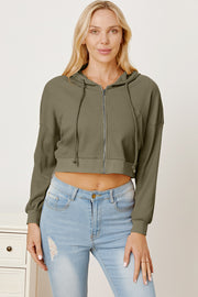Army green waffle knit cropped zip hoodie with drawstring hood and elastic cuffs.
