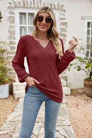 Burgundy eyelet yoke blouson sleeve top with v-neck and silver grommets