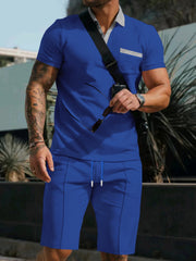 Blue polo shirt and shorts set with grey collar and pocket detail.