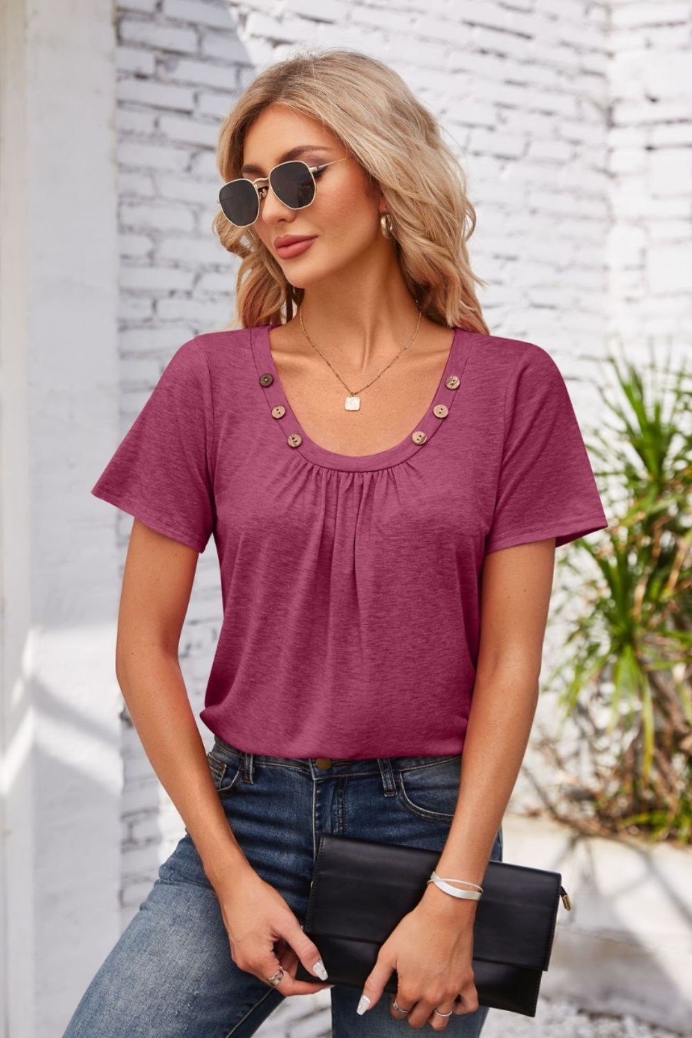 Button-trimmed gathered yoke top in watermelon pink with short sleeves and a scoop neckline.