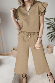 Camel textured loungewear set with zip-up top and ruffle sleeves, and wide-leg cropped pants.