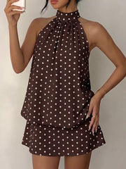 Coffee brown polka dot halter mini dress with gathered neckline and flared skirt.
