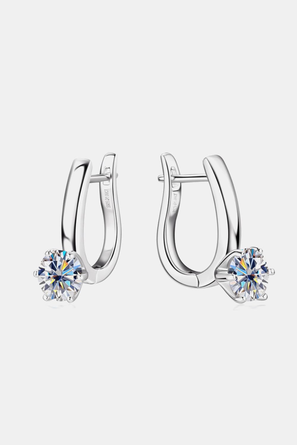 Silver huggie hoop earrings with a single sparkling solitaire gem on each.