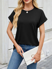 Black crew neck t-shirt with cuffed short sleeves, styled casually with jeans and a clutch.