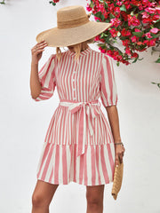 Blush pink and white striped shirred waist dress with puff sleeves and tiered skirt.