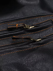 Black faux leather motorcycle coat detail with brass zippers and orange stitching.
