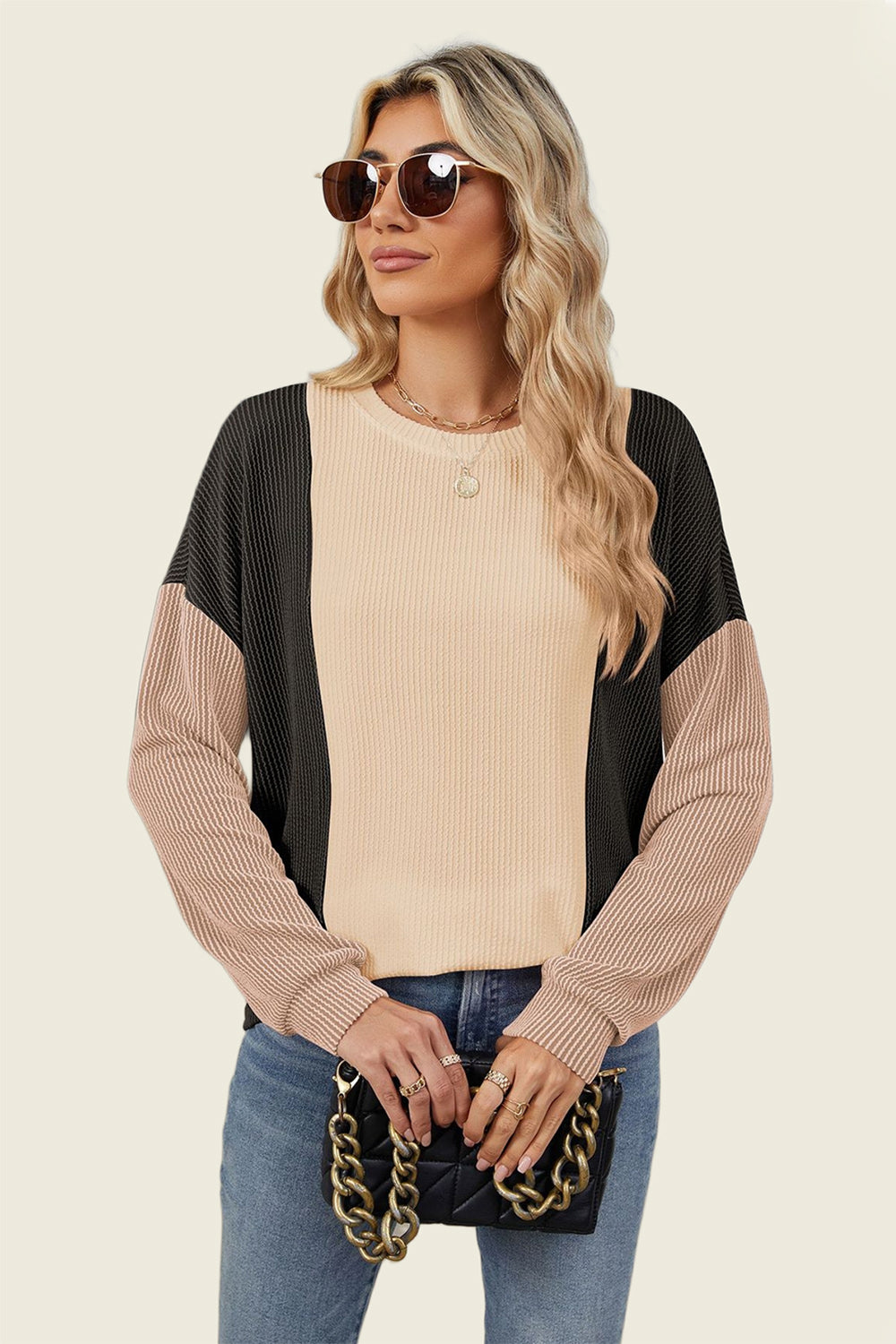 Colorblock waffle knit pullover sweater in tan, black, and dusty pink with crewneck and long sleeves.