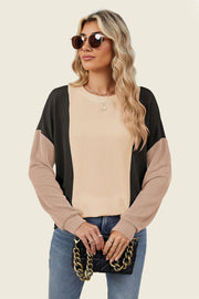 Colorblock waffle knit pullover sweater in tan, black, and dusty pink with crewneck and long sleeves.