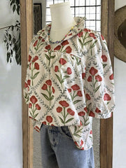 Ruffle collar blouse with red floral print and ruffled trim.