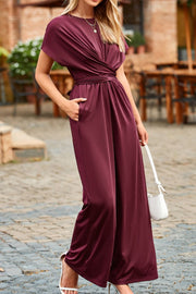 Maroon cap sleeve knot waist jumpsuit with wide legs and pockets.