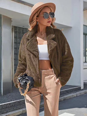 Faux fur biker jacket in chocolate brown with a wide lapel and open front.