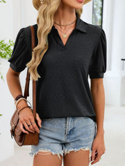 Black eyelet collar top with puff sleeves and v-neck, styled with denim shorts.