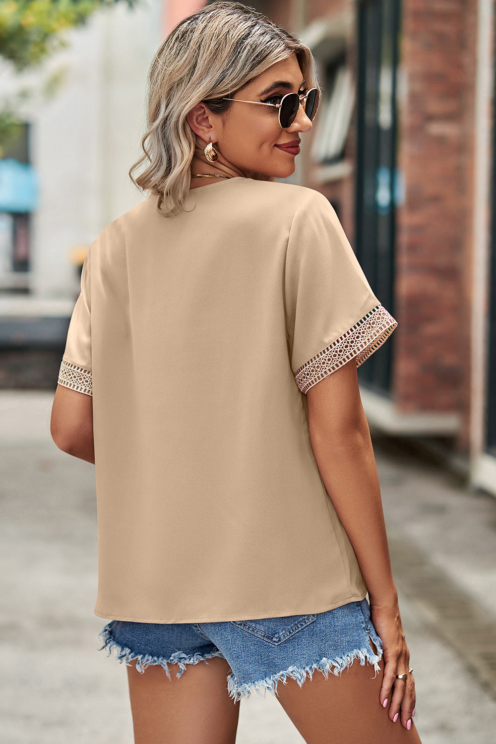Cream lace trim v-neck blouse with short sleeves.