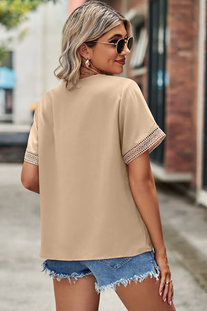 Cream lace trim v-neck blouse with short sleeves.