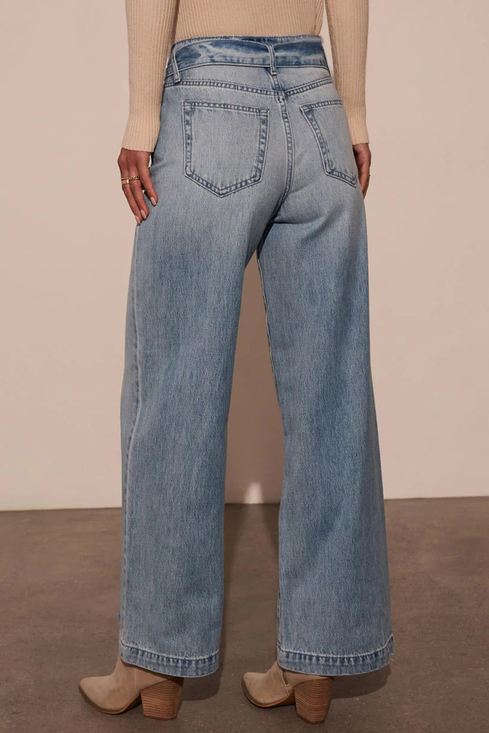 Belted wide-leg denim trousers in medium wash, shown from the back with a casual fit.