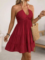Red halter neck ruffled mini dress with tiered skirt and ruched bodice.