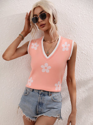 Coral knit tank top with white daisy print and contrast trim.